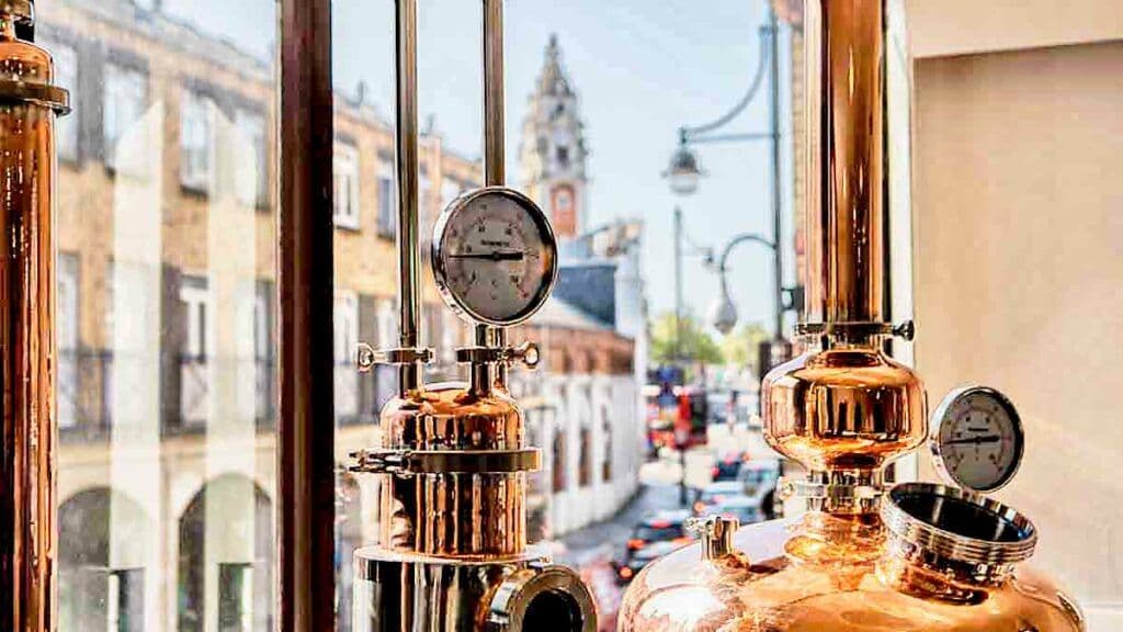The copper still at the BCC Distillery, with Brixton Lambeth Town Hall through the window
